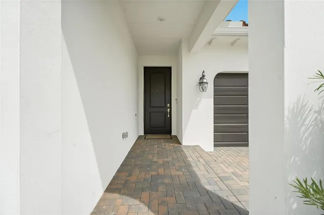 a view of a hallway with wooden floor and entryway