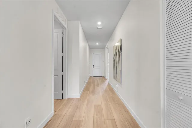 a view of a room with wooden floor