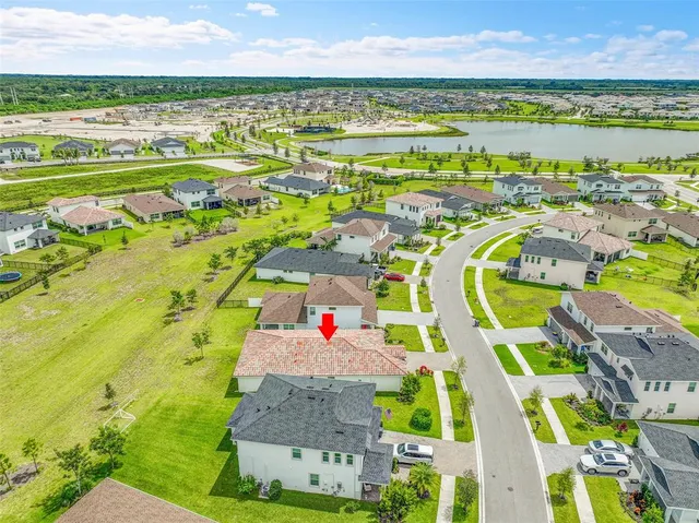 a view of a house with a yard and palm tree