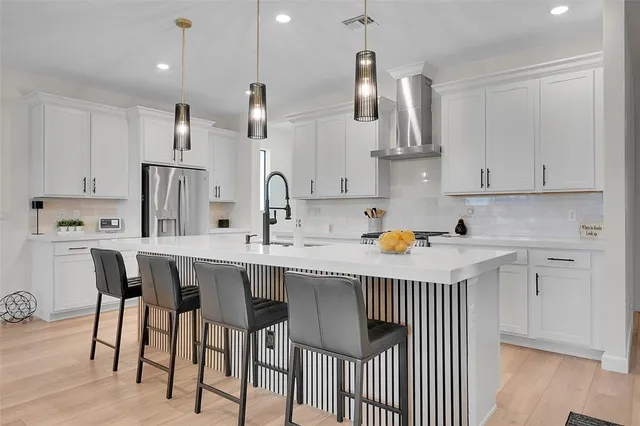 a kitchen with stainless steel appliances a sink stove and cabinets