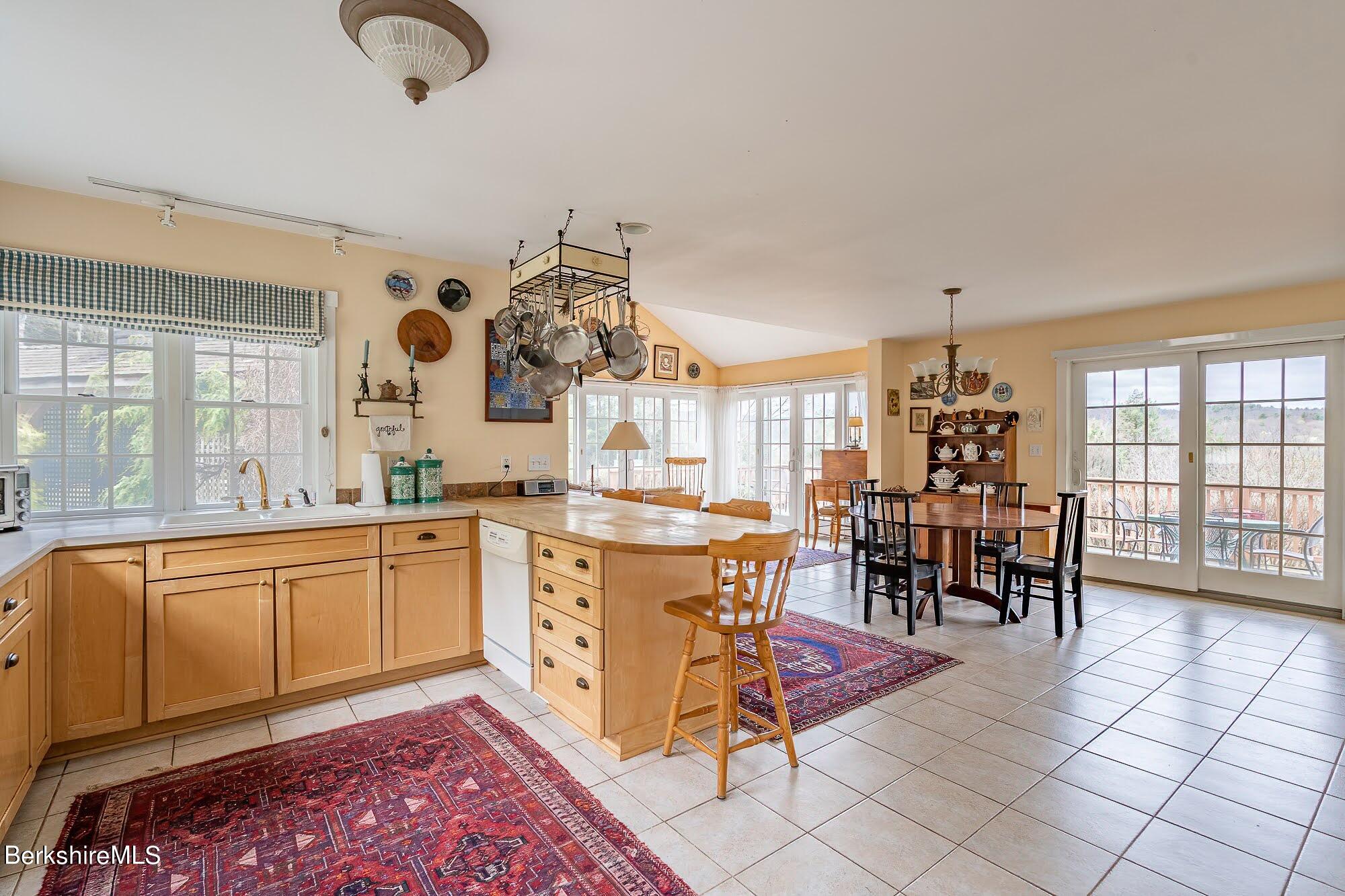 78 Mountain Road South Egremont, MA 01258 - Photo 13 of 34 a very nice looking open dining room with kitchen island granite countertop a table and chairs in it