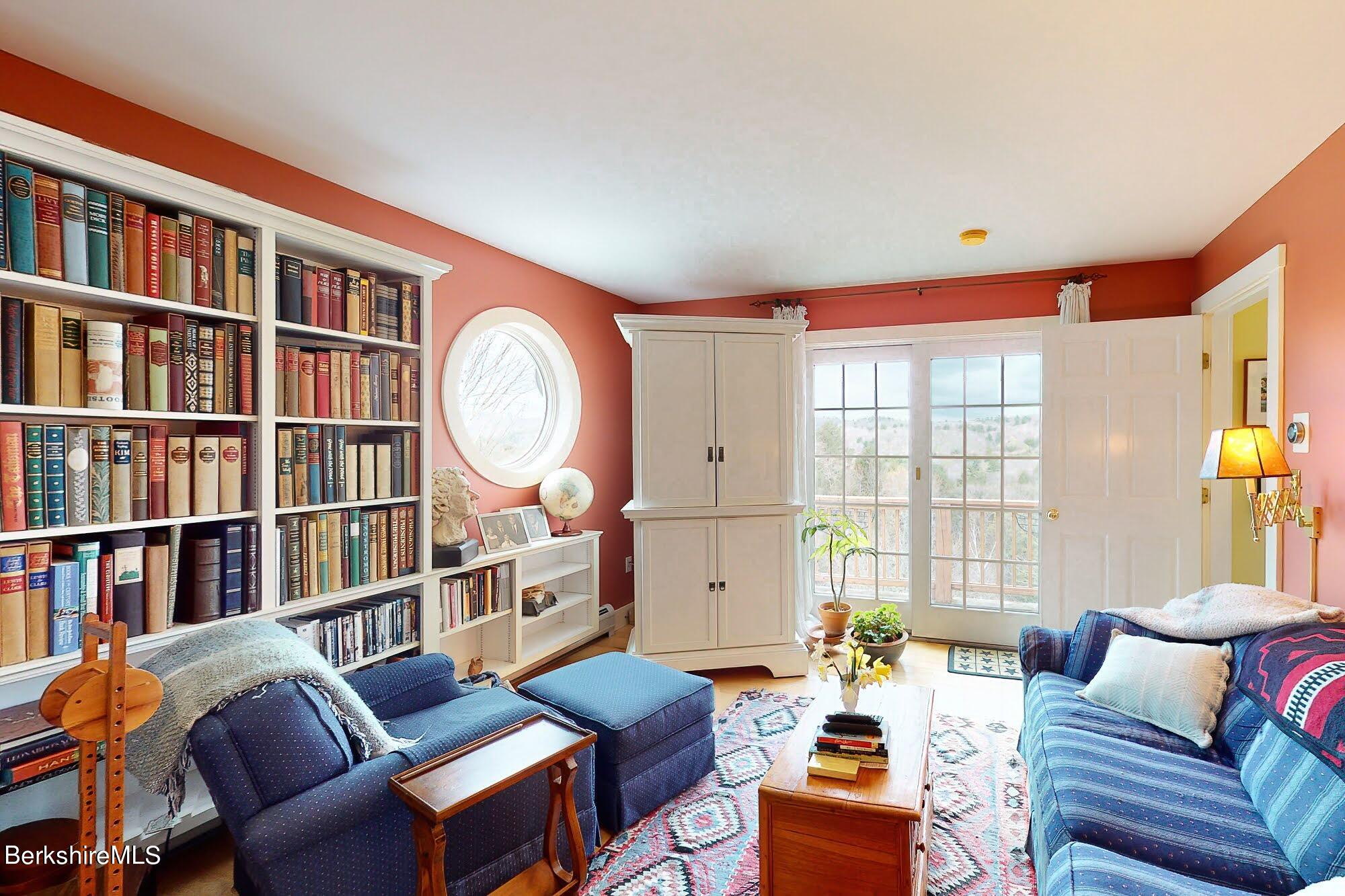 78 Mountain Road South Egremont, MA 01258 - Photo 19 of 34 a living room with furniture a window and a bookshelf