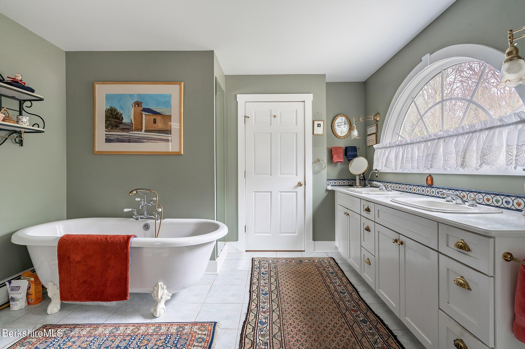 78 Mountain Road South Egremont, MA 01258 - Photo 24 of 34 a spacious bathroom with a double vanity sink a mirror and a bathtub