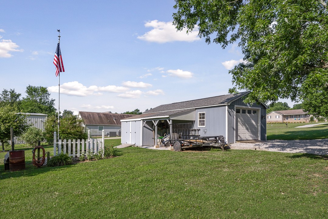 245 Faith-Rae Boulevard Morrison, TN 37357 - Photo 26 of 55 a front view of a house with a garden and trees