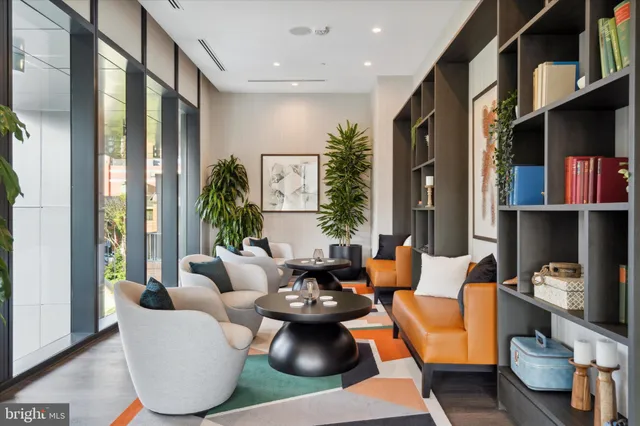 a living room with furniture and a book shelf