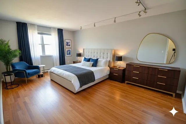 a bedroom with a bed and wooden floor