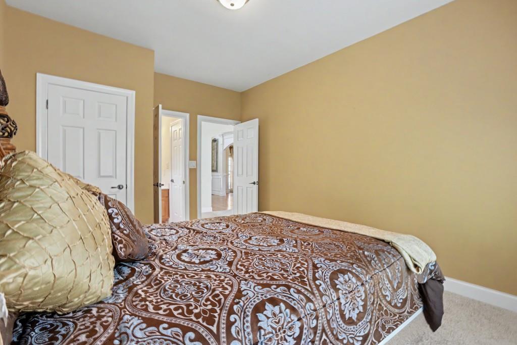 2123 Floral Ridge Drive Dacula, GA 30019 - Photo 26 of 56 a bedroom with a bed and a window