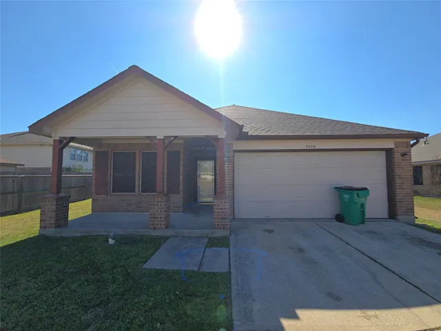 a front view of a house with a yard and sitting area