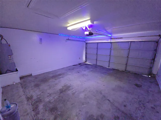 a view of a room with a ceiling fan and window