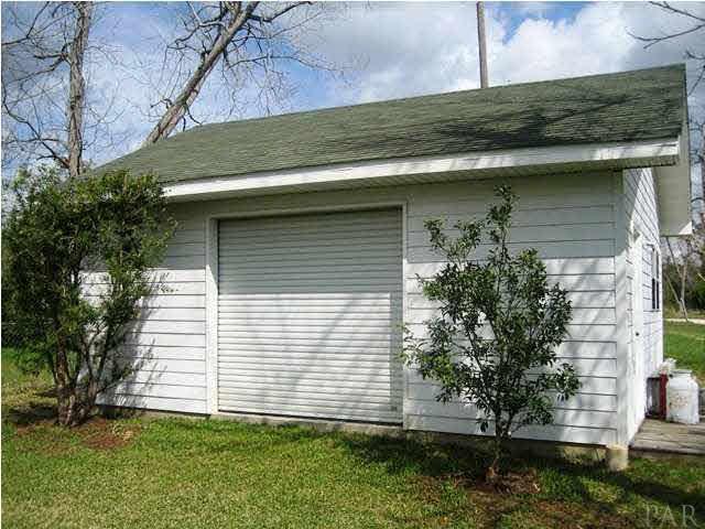 2060 Stallion Road Cantonment, FL 32533 - Photo 23 of 24 WORKSHOP HAS ROLL UP 10FT X 10 FT DOOR.