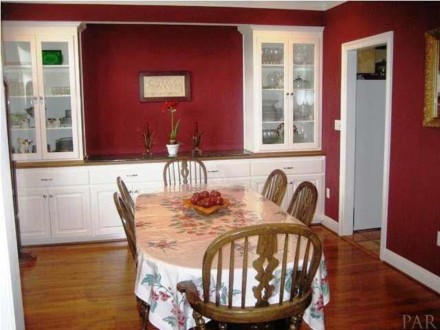 2060 Stallion Road Cantonment, FL 32533 - Photo 5 of 24 FORMAL DINING ROOM WITH WIDE MOLDINGS, BUILT IN CABINETS, SOME WITH GLASS DOORS