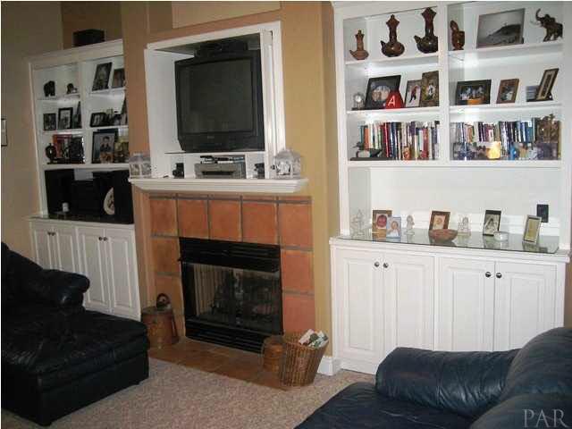 2060 Stallion Road Cantonment, FL 32533 - Photo 8 of 24 GREATROOM HAS WALL OF BUILT INS, INCLUDING TV CABINET WITH CLOSABLE DOORS ABOVE THE GAS FIREPLACE