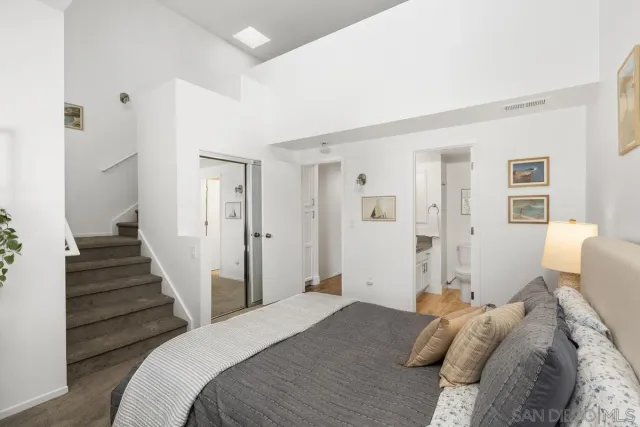 a bedroom with a bed and a view of room