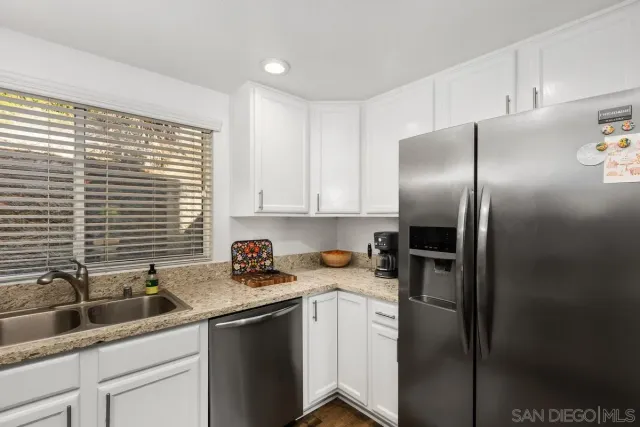 a kitchen with a sink cabinets and stainless steel appliances