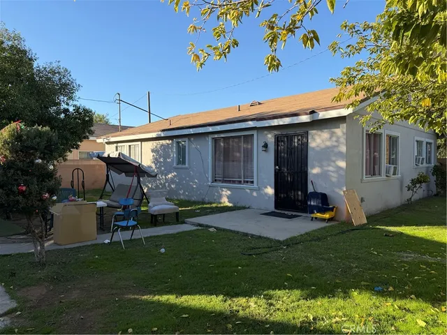 a view of a backyard with plants and a patio