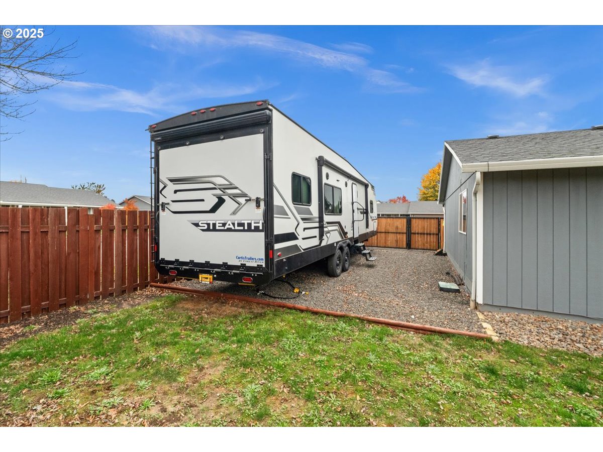 2788 South Beech Street Cornelius, OR 97113 - Photo 32 of 40 a backyard of a house with lawn chairs and a stove
