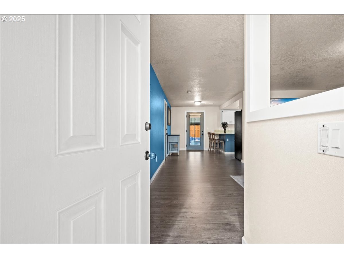 2788 South Beech Street Cornelius, OR 97113 - Photo 7 of 40 a view of a hallway with wooden floor and furniture