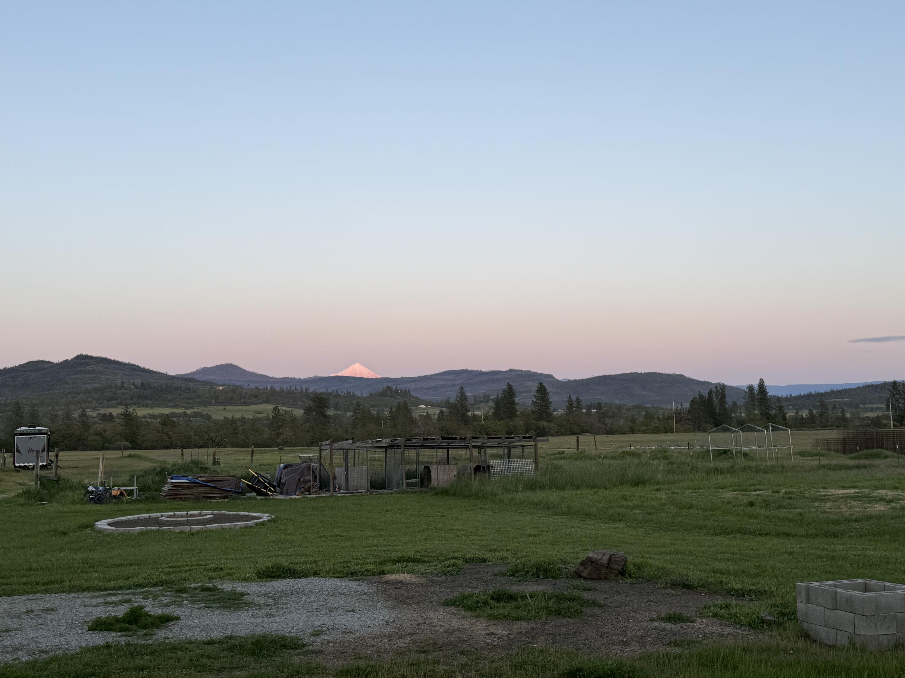 380 Greenleaf Drive Eagle Point, OR 97524 - Photo 4 of 31 a view of a grassy field with mountains in the background