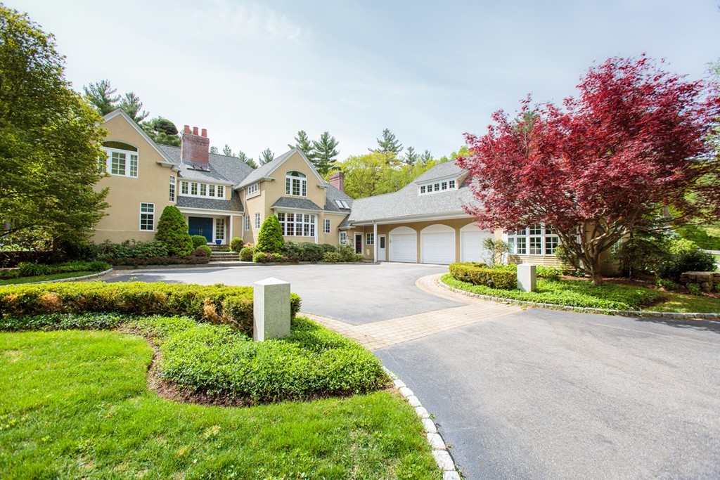 144 Sandy Pond Road Lincoln, MA 01773 - Photo 1 of 30 a front view of a house with a garden and fountain