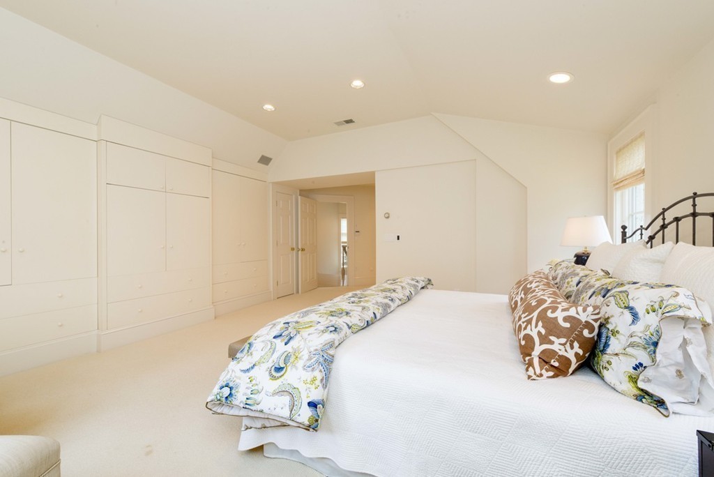 144 Sandy Pond Road Lincoln, MA 01773 - Photo 13 of 30 a bedroom with a bed and a chandelier