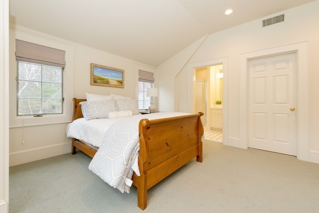 144 Sandy Pond Road Lincoln, MA 01773 - Photo 16 of 30 a spacious bedroom with a bed and a window