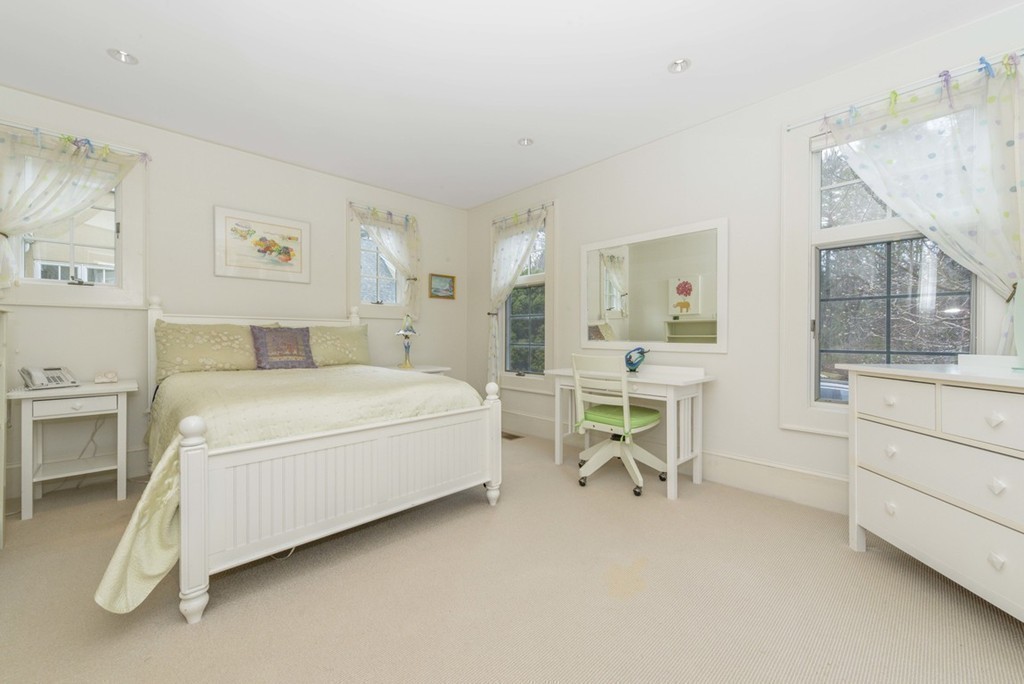144 Sandy Pond Road Lincoln, MA 01773 - Photo 18 of 30 a bed room with a bed and a chair