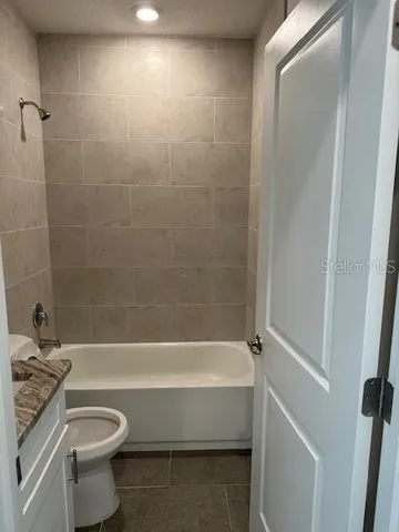 a bathroom with a sink a toilet and a bathtub