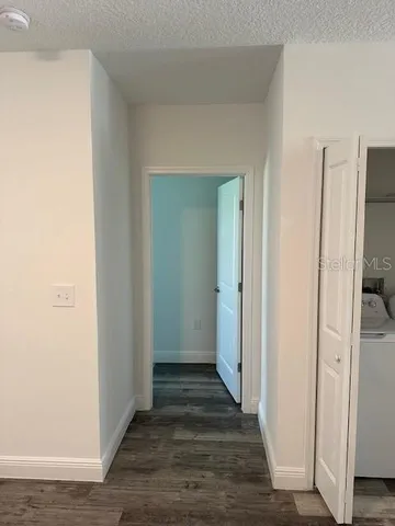 a view of a hallway with wooden floor