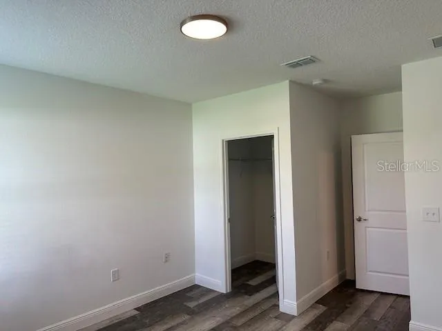 a view of a room with wooden floor