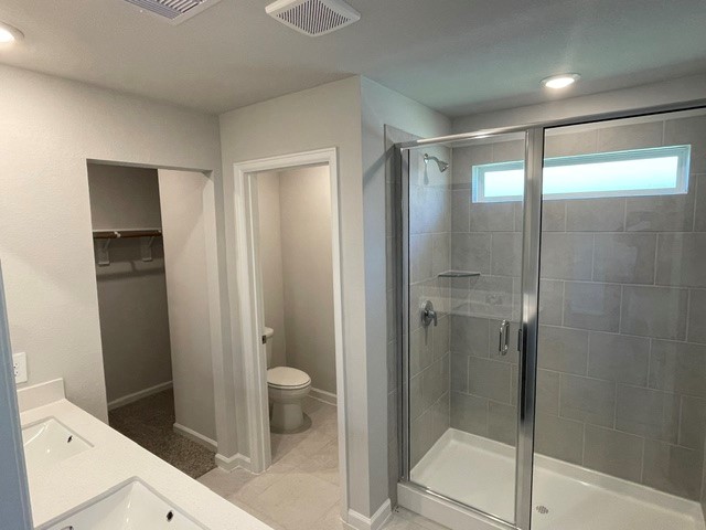 1024 Legrand Street Brenham, TX 77833 - Photo 5 of 7 a bathroom with a glass shower door