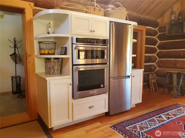 a kitchen with stainless steel appliances granite countertop a refrigerator and a stove