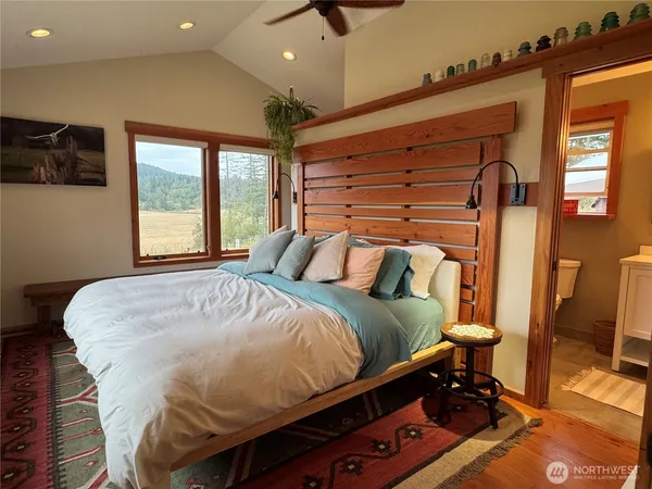 a bedroom with a bed and a large window