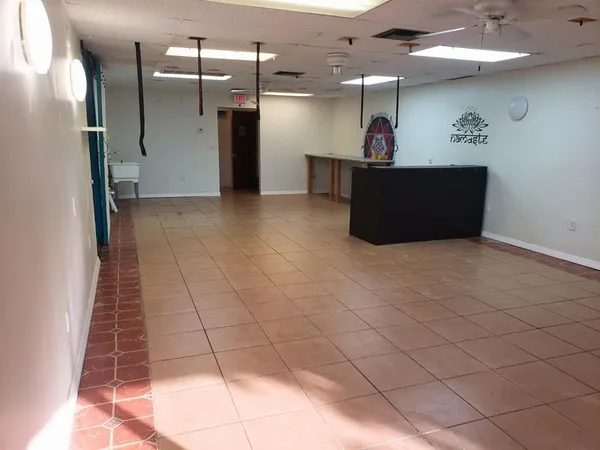 a view of a hallway and a livingroom with furniture