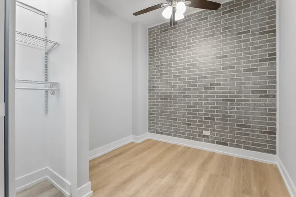 a view of empty room with wooden floor