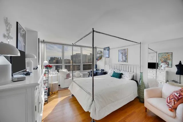 a bedroom with two beds and a flat screen tv