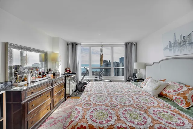 a bed room with a bed and a large window