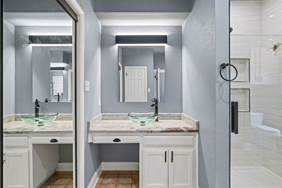 128 Mockingbird Lane Georgetown, TX 78633 - Photo 19 of 40 a bathroom with a granite countertop sink and a mirror