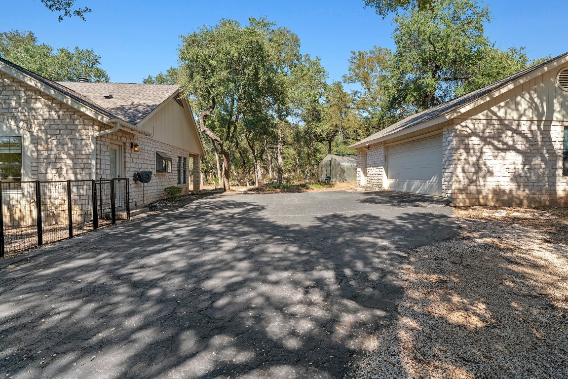 128 Mockingbird Lane Georgetown, TX 78633 - Photo 4 of 40 a backyard of a house with large trees and outdoor seating