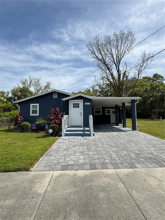 5237 Davisson Avenue Orlando, FL 32810 - Photo 1 of 1 a front view of a house with a yard and a garage