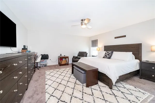 a spacious bathroom with a granite countertop sink mirror and a toilet