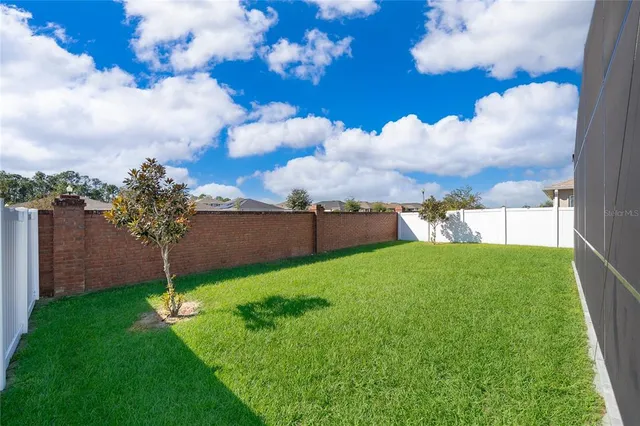a view of house with backyard