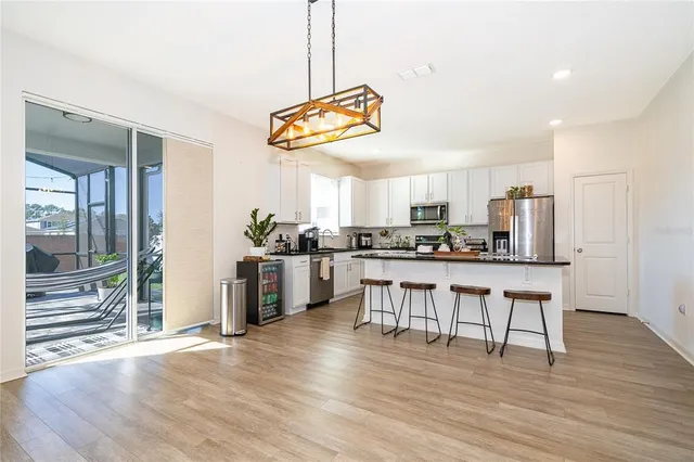 a kitchen with stainless steel appliances granite countertop a refrigerator and a stove top oven