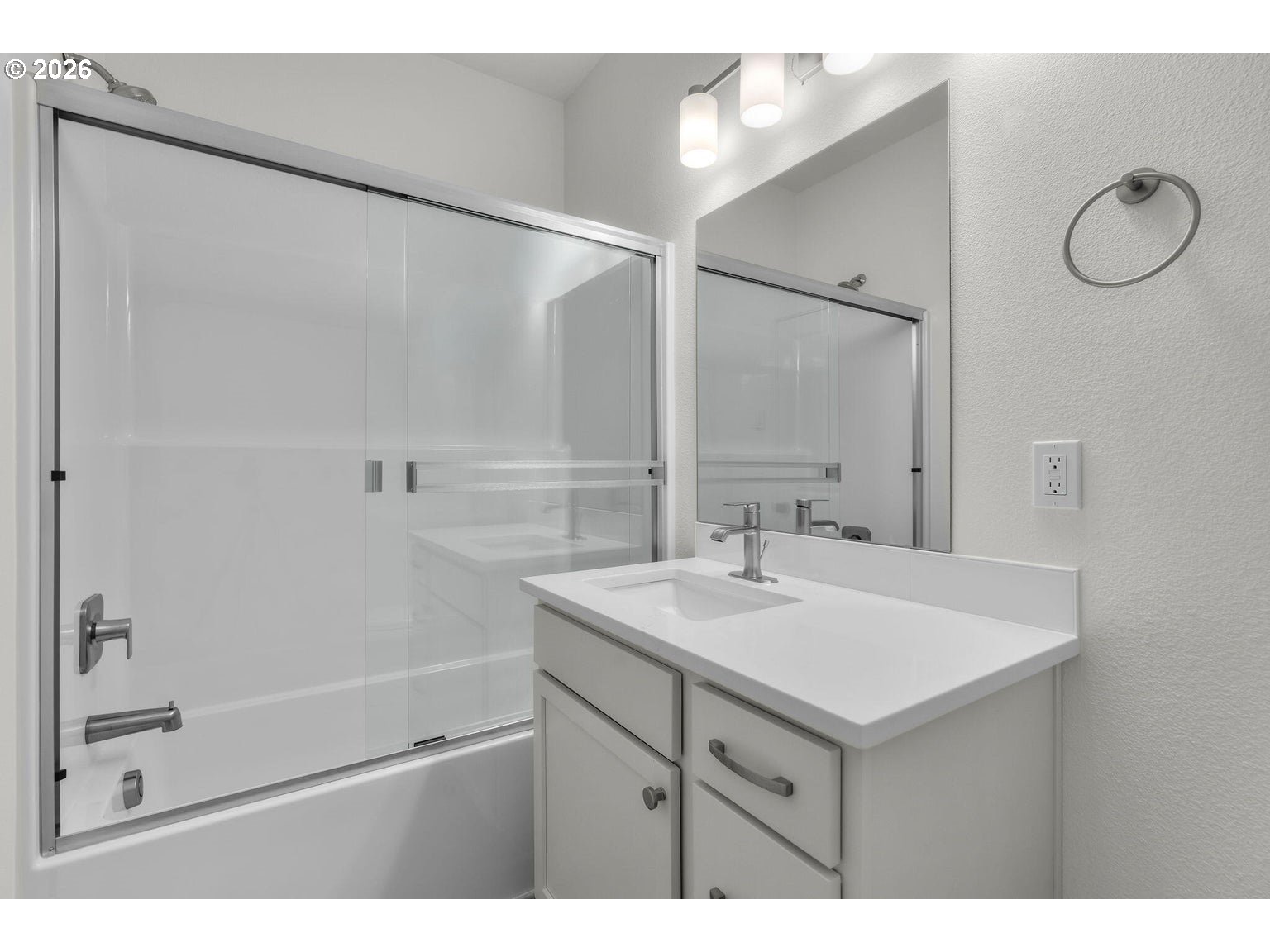 510 Southwest 6th Street Madras, OR 97741 - Photo 13 of 22 a bathroom with a shower sink vanity and mirror