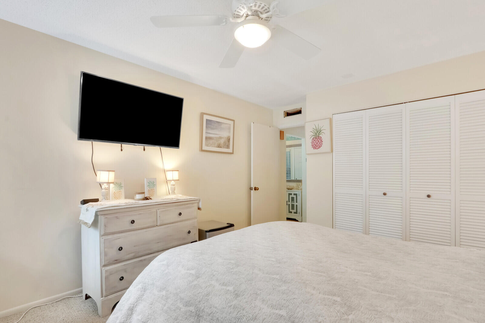 2051 Northeast Ocean Boulevard, Unit A12 Stuart, FL 34996 - Photo 13 of 39 a bedroom with a bed and a flat screen tv