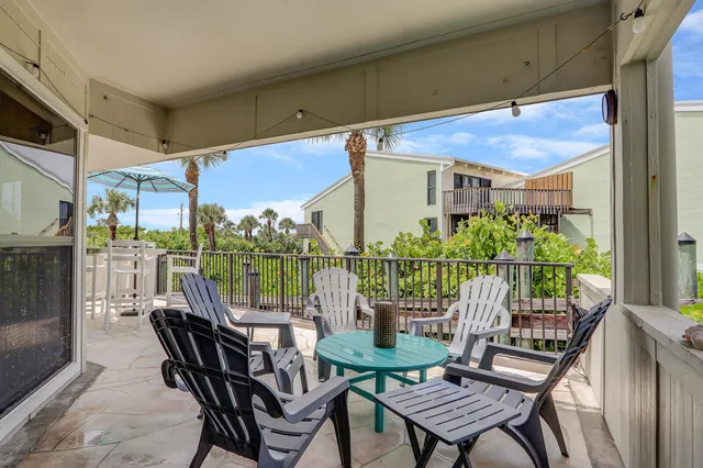 a view of a chairs and table in the patio