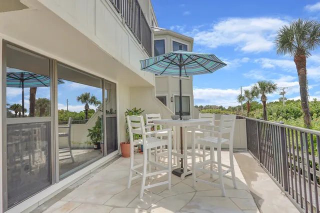 a view of a balcony with a table and chairs