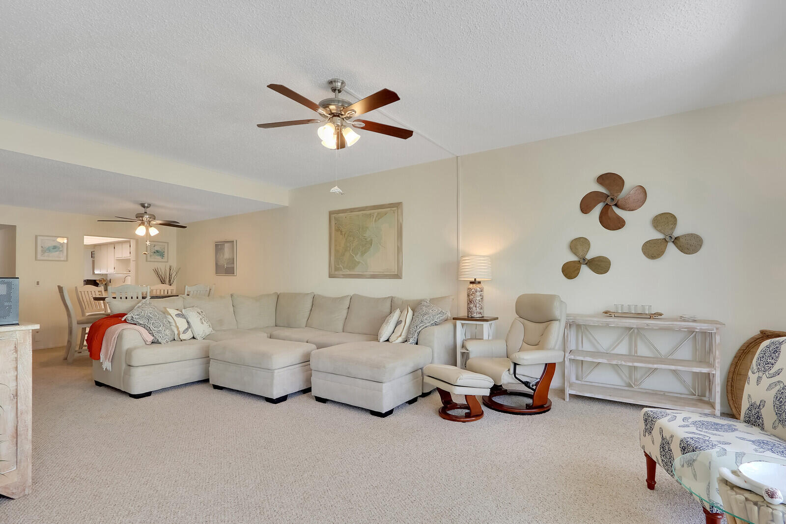 2051 Northeast Ocean Boulevard, Unit A12 Stuart, FL 34996 - Photo 4 of 39 a living room with furniture and a chandelier