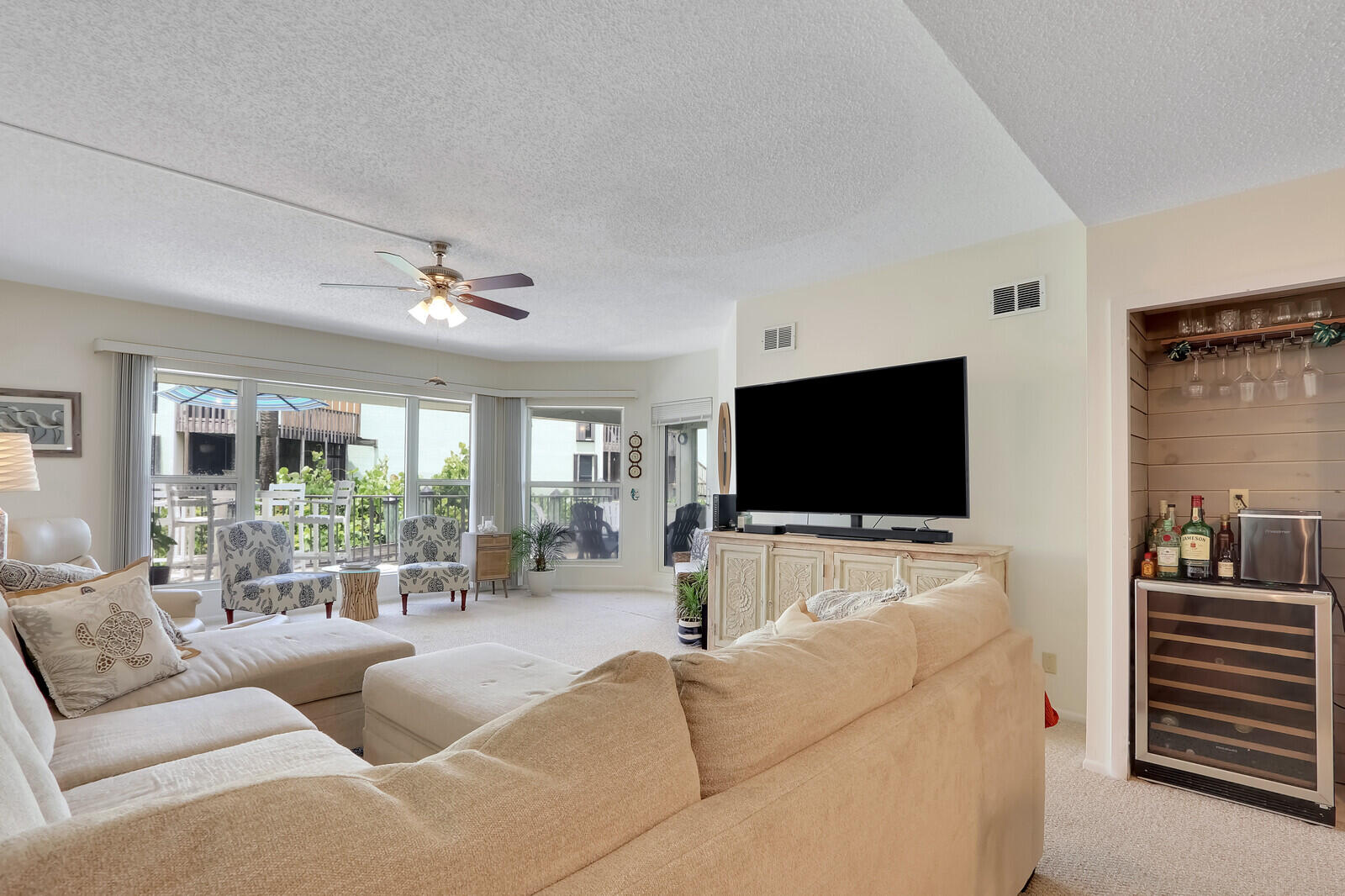 2051 Northeast Ocean Boulevard, Unit A12 Stuart, FL 34996 - Photo 5 of 39 a living room with furniture and a flat screen tv