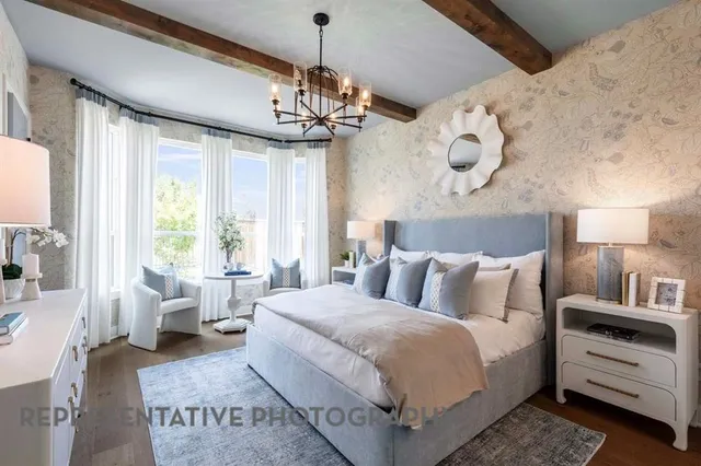 a bedroom with a large bed and a chandelier