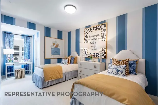 a bedroom with two beds and painting on the wall